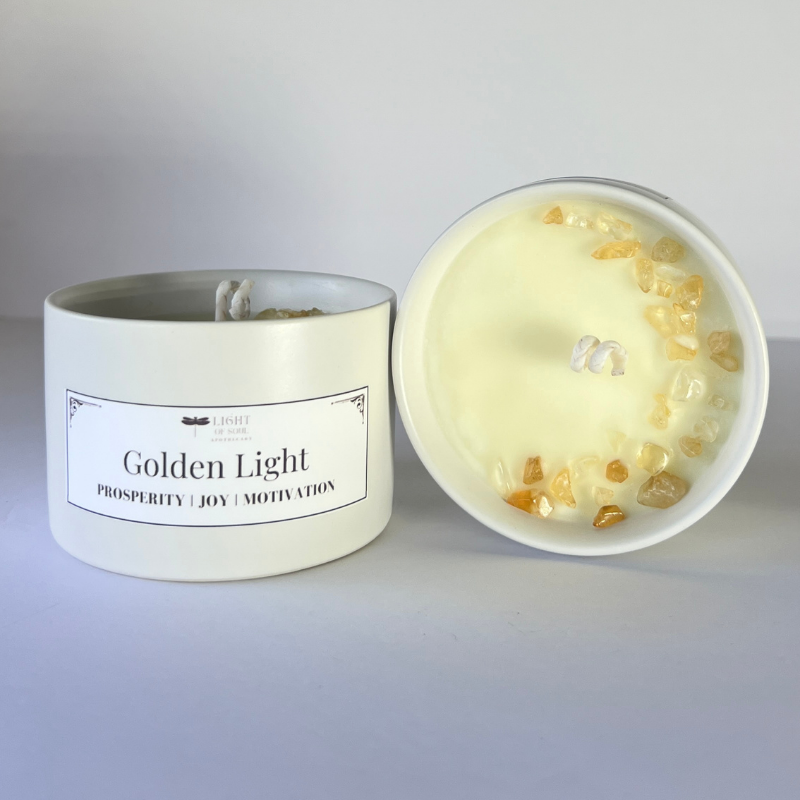Candle with a label 'Golden Light' on a gray background
