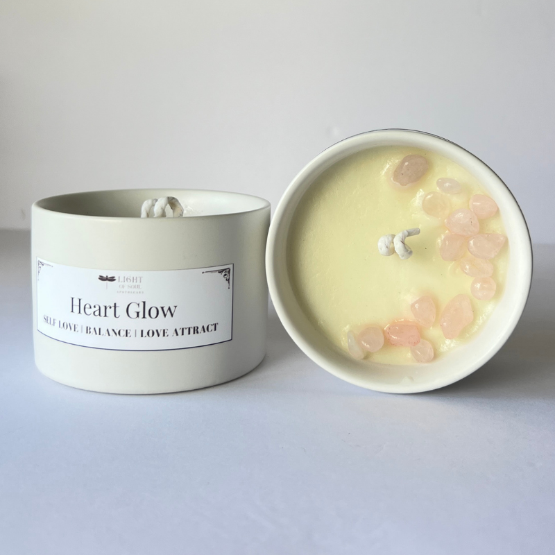 Soy Candle labeled 'Heart Glow' with a rose quartz on a light gray background