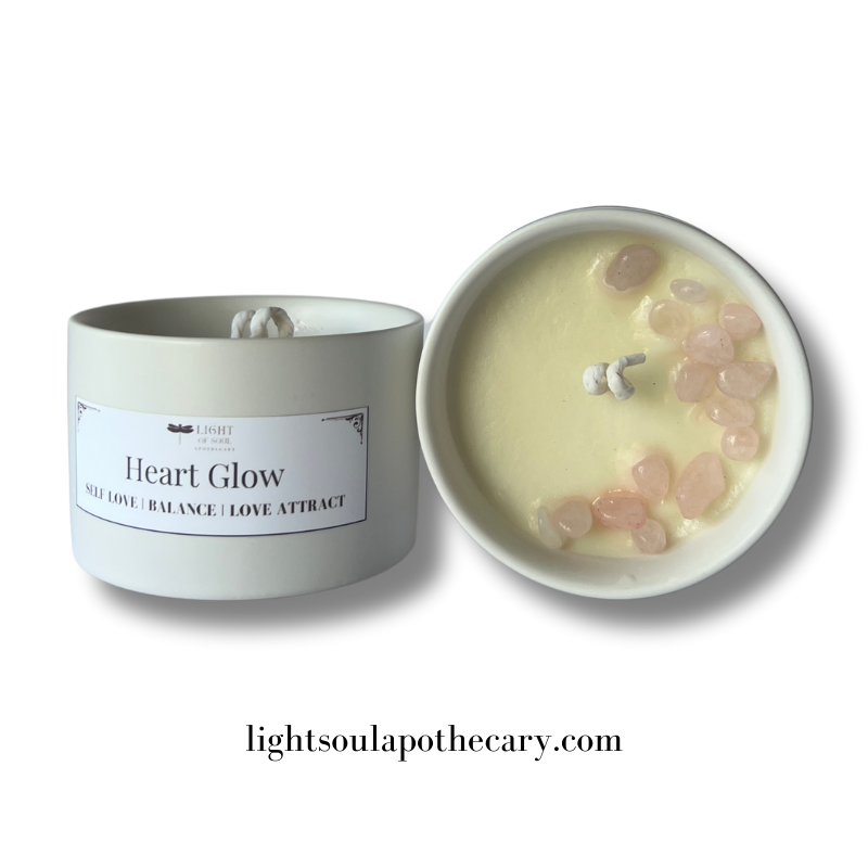 Candle labeled 'Heart Glow' with stones rose quartz inside on a white background