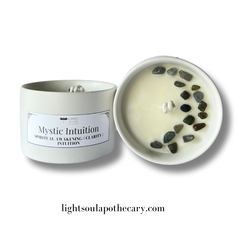 Candle with labradorite stone decorative stones and packaging labeled 'Mystic Intuition' on a white background.