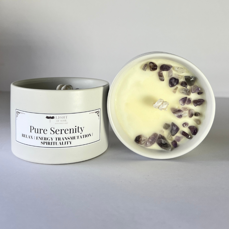 Candle labeled 'Pure Serenity' with amethyst stones on a gray background