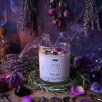 Candle labeled 'Hecate Light of Soul Apothecary' surrounded by lavender, crystals, and decorative herbs