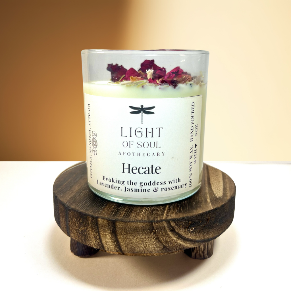 Candle labeled 'Hecate' from 'Light of Soul Apothecary' on a wooden stand for aromatherapy lavender_jasmine_rosemary