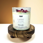 Candle labeled 'Hecate' from 'Light of Soul Apothecary' on a wooden stand for aromatherapy lavender_jasmine_rosemary